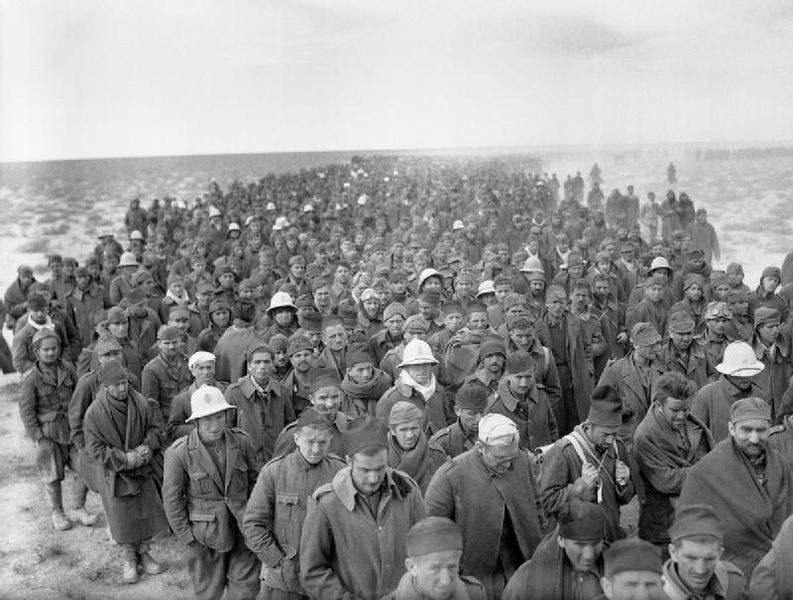 Italian prisoners captured during the assault on Bardia, Libya, march to a British army base on 6 January 1941 (Imperial War Museum: E 1579)