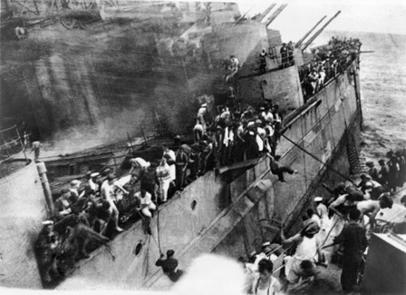 Crew of battleship HMS Prince of Wales abandoning ship, off Malaya, 10 Dec 1941 (Australian War Memorial: P02018.055)