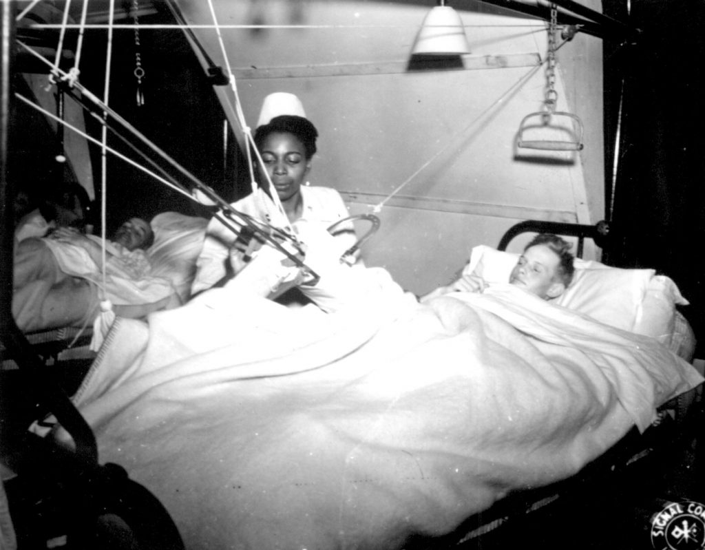 African-American US Army nurse Lt. Florie E. Gant tending a prisoner-of-war patient, England, 7 Oct 1944 (US National Archives)
