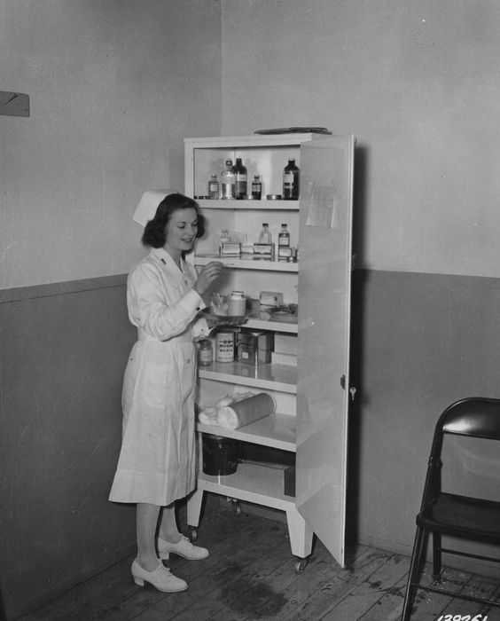 Army Nurse Betty Evans checks thermometers by the medication cabinet, 8 April 1942, Iceland (US Army Medical Department, Office of Medical History)