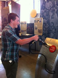 My son humoring his mother and operating the riveting gun exhibit at the Rosie the Riveter WWII Home Front Museum, Richmond, CA (May 2014)