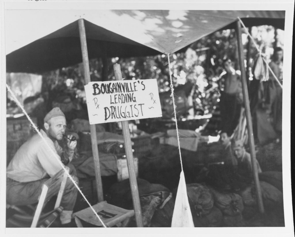 An enterprising Navy Pharmacist's Mate sets up his operation under a tent at Cape Torokina, Bougainville, circa 1-9 November 1943, soon after the initial landings there (US National Archives: 80-G-56402)