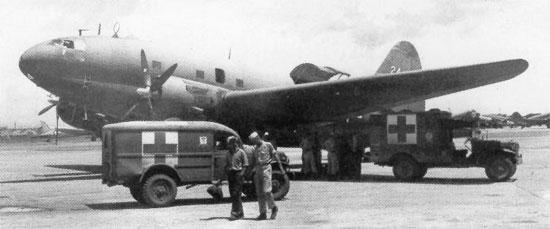 Dodge ambulances standing by C-46 Commando aircraft at Clark Field, Manila, Philippine Islands, 29 Sep 1945 (public domain via WW2 Database)