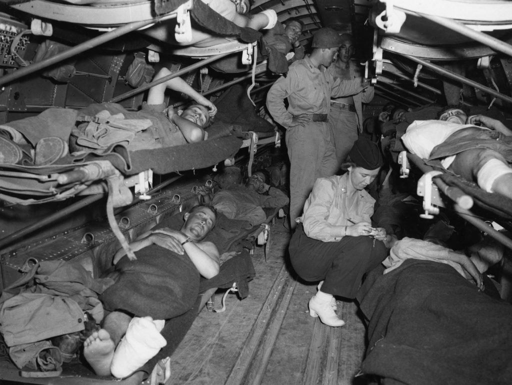 Lt. Katye Swope of the 802nd Medical Air Evacuation Transport Squadron checks patients being evacuated from Agrigento, Sicily, to North Africa for further medical treatment, 25 July 1943 (US Air Force photo)