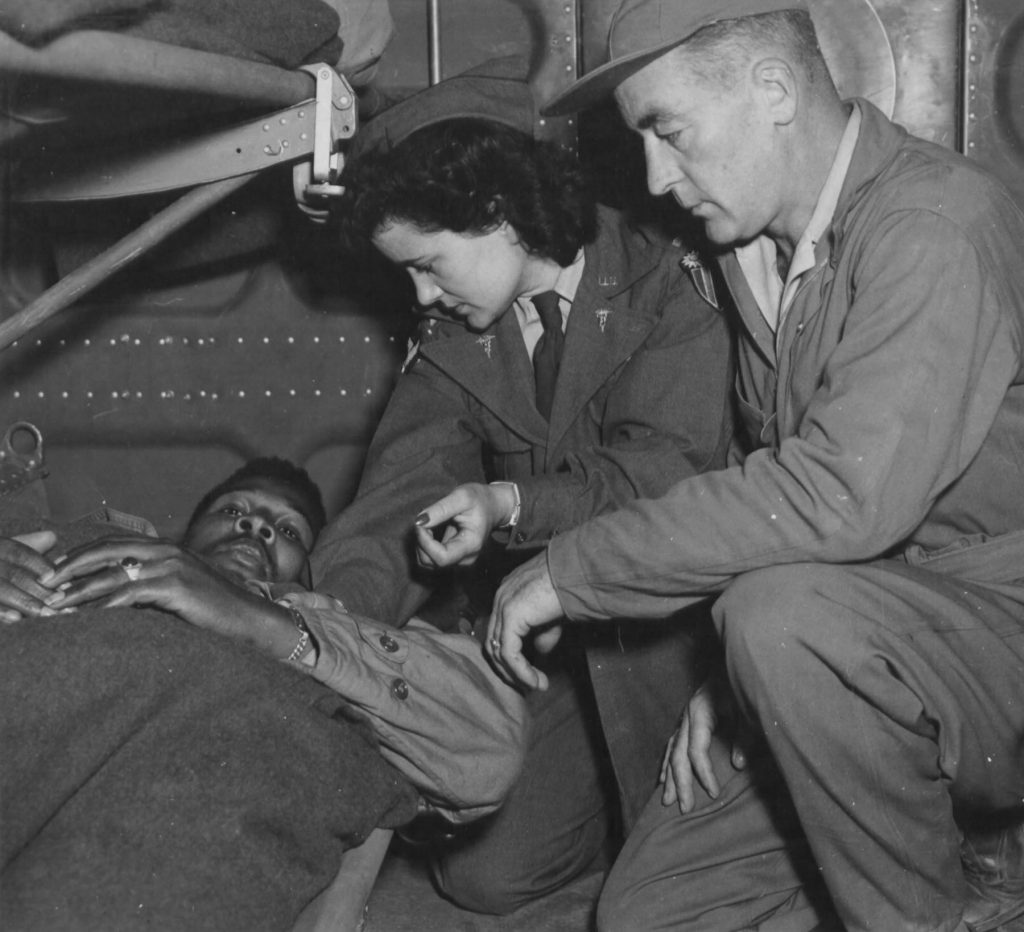 Air evacuation team from 803rd Medical Air Evacuation Transportation Squadron, Lt. Pauline Curry and Tech. Sgt. Lewis Marker, check a patient on a flight over India. (US Air Force photo)