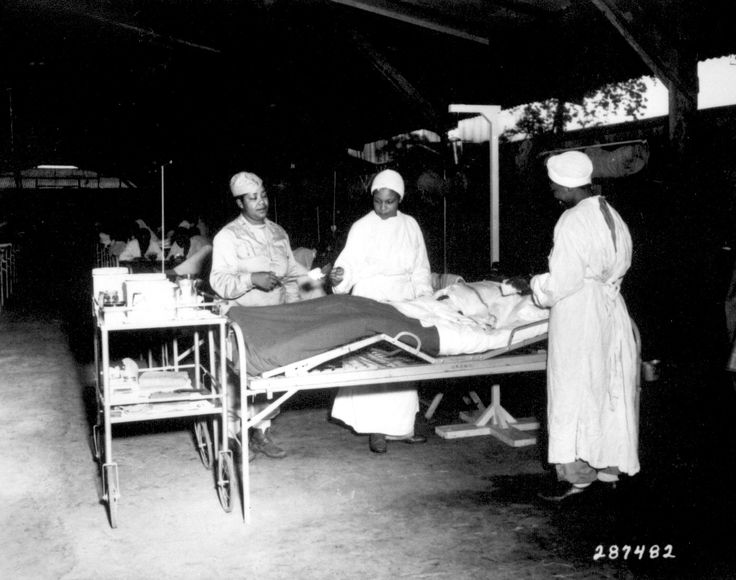 African-American US Army nurses Lt Prudence Burns, Lt Elcena Townscent, and a 3rd nurse treating Sgt Lawrence McKreever 268th Station Hospital, Milne Bay, New Guinea, 22 Jun 1944 (US National Archives)