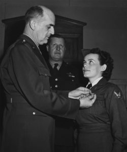 Brig. Gen. David N.W. Grant, Air Surgeon of the Army Air Forces, pins wings on Lt. Geraldine Dishroon, honor graduate at Bowman Field, Kentucky, during the school’s first formal flight nurse graduation on Feb. 18, 1943 (US National Archives)