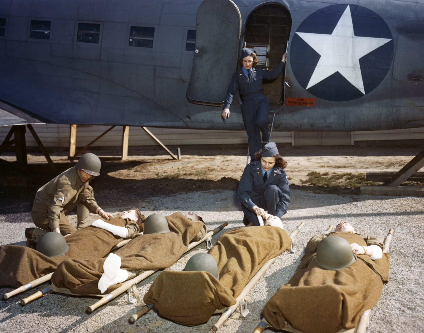 At the Army Air Force School of Air Evacuation at Bowman Field, KY, student flight nurses learn how to handle patients with the aid of a mock-up fuselage of a Douglas C-47 transport. (US Air Force photo)