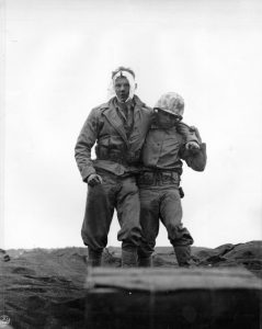Wounded US Marine being helped by a comrade, Iwo Jima, 20 Feb 1945 (US Marine Corps photo)
