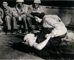 Flight nurse Ens. Jane Kendeigh, US Navy, caring for wounded Marine William J Wycoff on Iwo Jima, March 3, 1945 (US Navy photo)