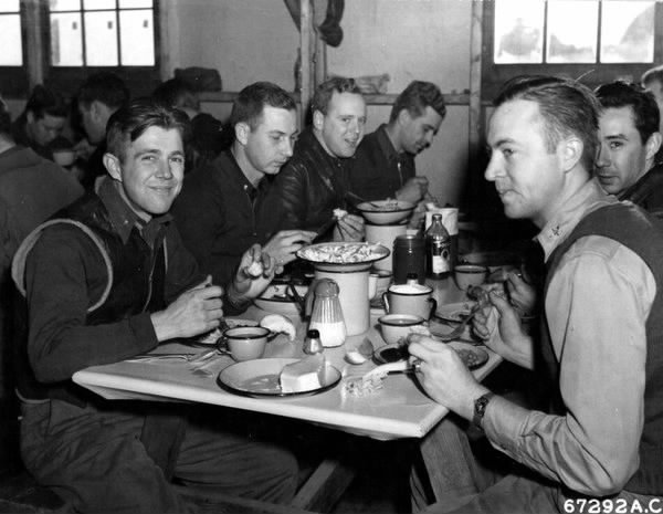 At Alexai Point, Attu, Aleutian Islands, officers of the US 77th Bomb Group and the 54th Fighter Group do justice to the traditional Thanksgiving dinner –the first one celebrated by military personnel on former American territory recaptured from the Japanese, 25 November 1943 (US Army Air Force photo)