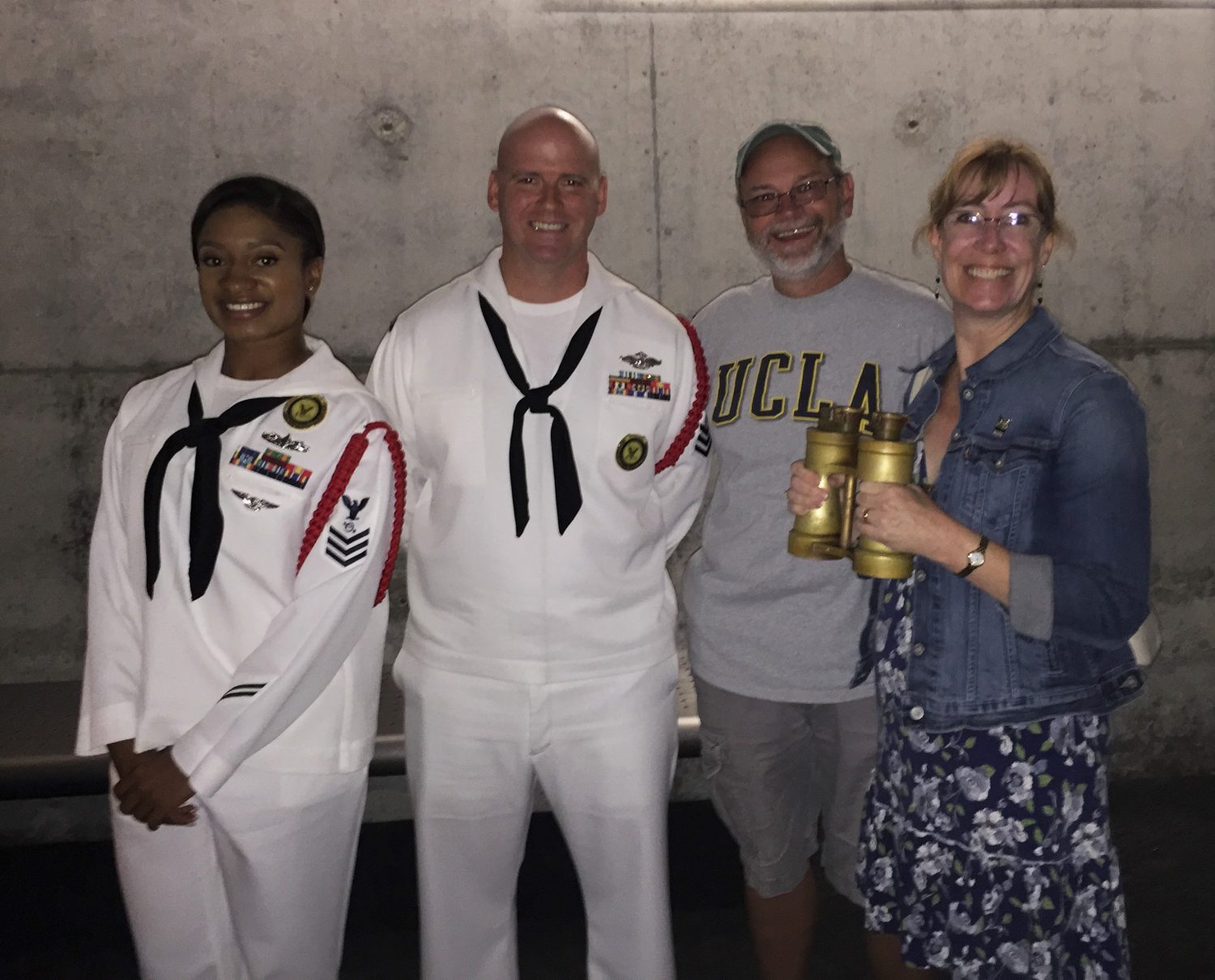 Two Navy docents from Great Lakes at the Chicago Museum of Science and Industry (our son's RDC is the gentleman in white), my husband, and me holding the actual binoculars from U-505! (Photo: Sarah Sundin, August 2016)