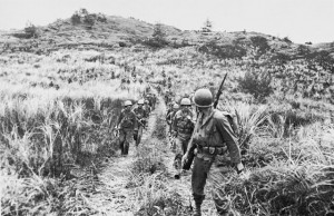 Men of Company B, 305th RCT, moving out from high ground on Guam (US Army Center of Military History)