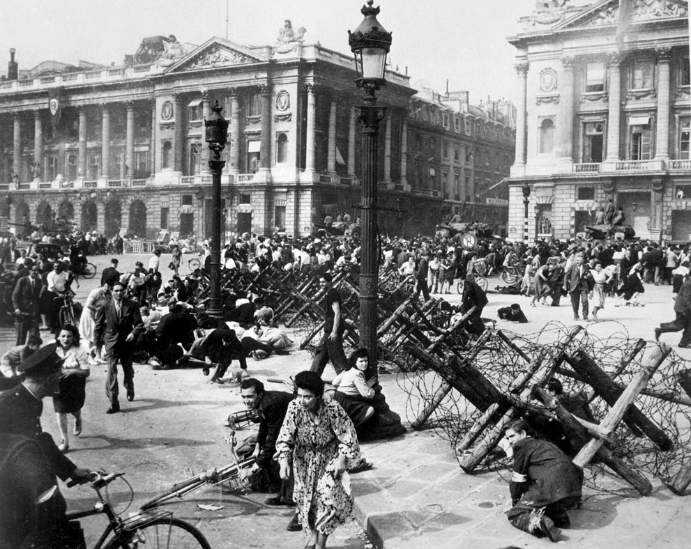 French civilians seeking cover as a German sniper opens fire, Paris, France, 26 Aug 1944 (US Army photo)