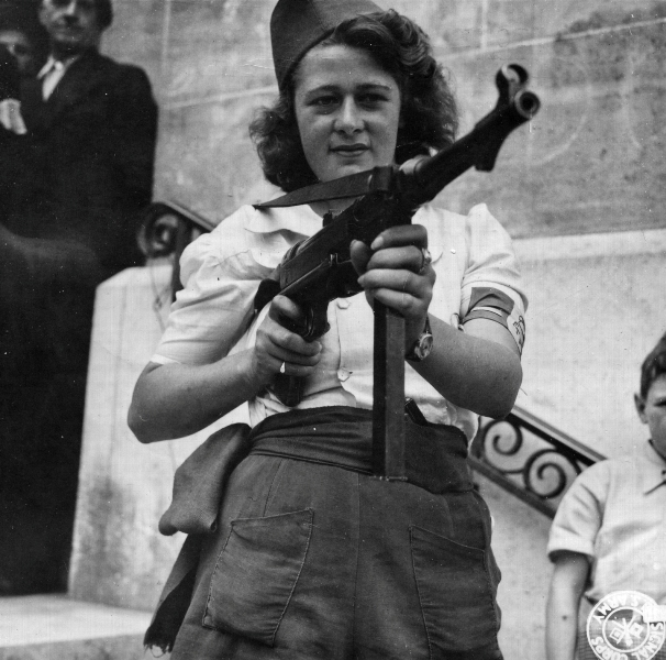 French resistance fighter Simone Segouin (nom de guerre Nicole Minet) posing with a MP 40 submachine gun in Paris, 23 Aug 1944 (US Army Signal Corps photo)