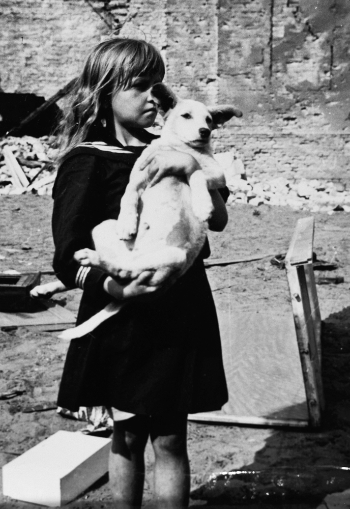 Girl holding her dog in devastated Warsaw, Poland, 5 September 1939 (US Holocaust Museum)