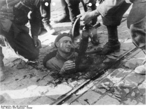 Polish insurgent fighter surrendering from the sewers under Warsaw, 27 September 1944 (German Federal Archive. Photographer: August Ahrens, Bild 146-1994-054-30)