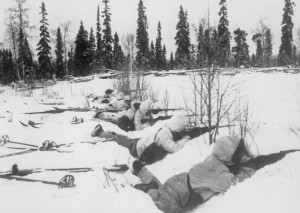 Finnish ski patrol, lying in the snow on the outskirts of a wood in Northern Finland, on the alert for Soviet troops, 12 January 1940. (Imperial War Museum)