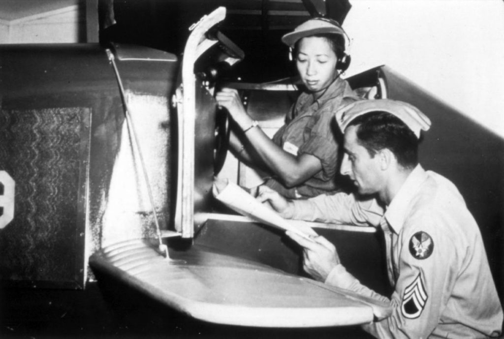 WASP Hazel Ying Lee reviews her performance after a session in a Link trainer, 1944 (US Air Force photo)