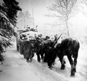 Troops of US 82nd Airborne Division marching behind M4 Sherman tank in a snowstorm toward German occupied town of Herresbach, Belgium, 28 Jan 1945 (US Army photo)