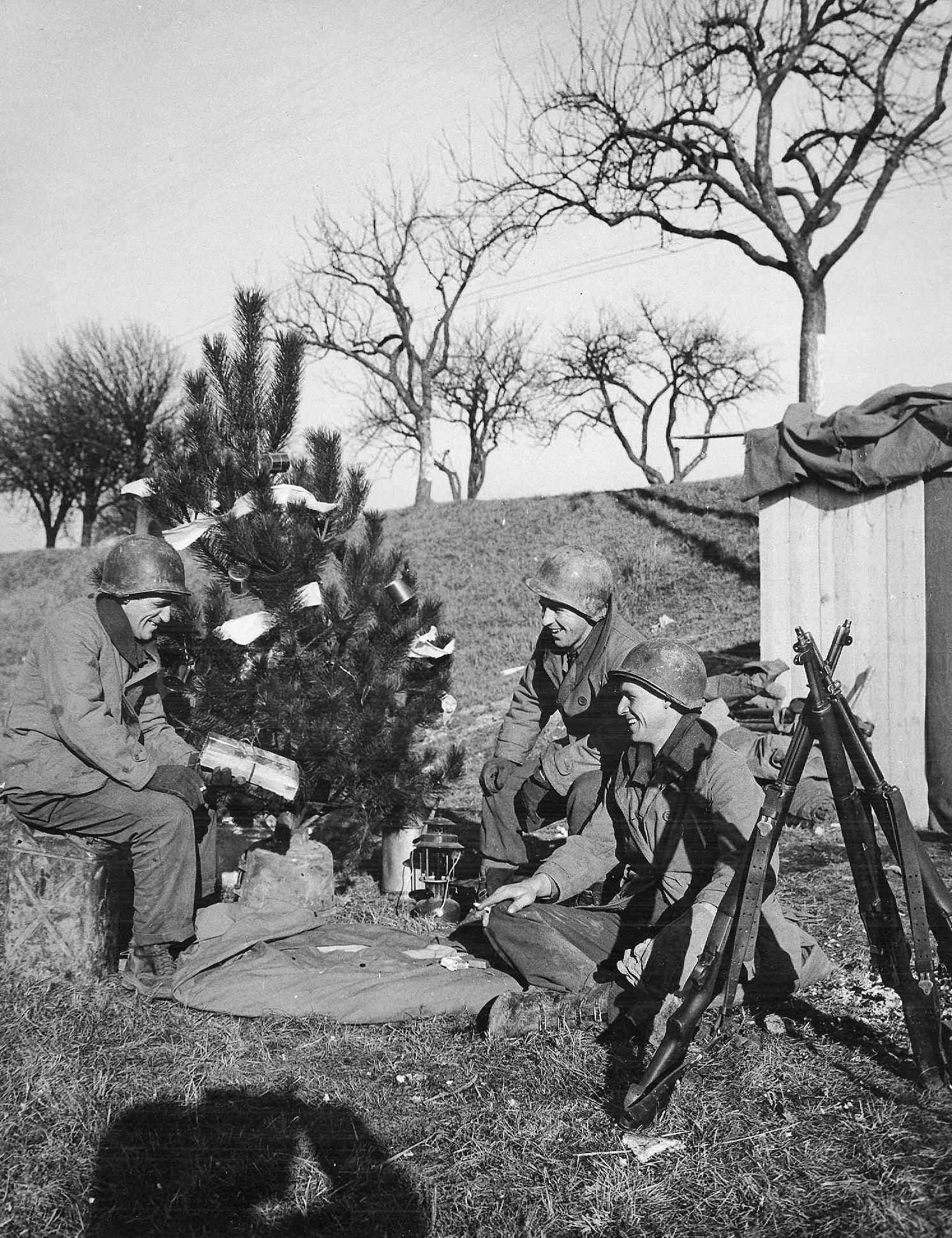 Soldiers of the 463rd Combat Engineers in France near the German border observe Christmas, 25 Dec 1944; note K-ration cans as ornaments (US Army Signal Corps photo)