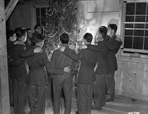 Pennsylvania soldiers in 10th Regiment in Camp Lee’s Quartermaster Replacement Center sing carols around the tree, Camp Lee, VA, December 1941 (US Army Center of Military History)