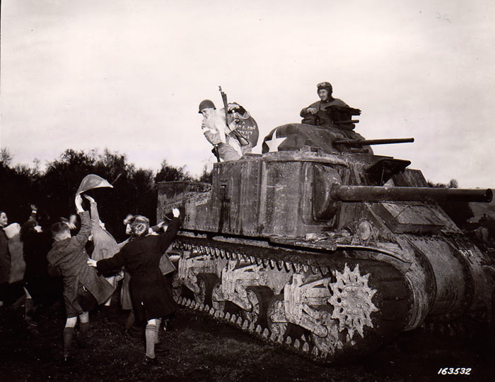 Sgt. Hiram Prouty of US 175th Infantry Regiment dressed as Santa Claus, arriving on a M3 medium tank, Perham Down, England, 5 December 1942 (US Army Signal Corps)