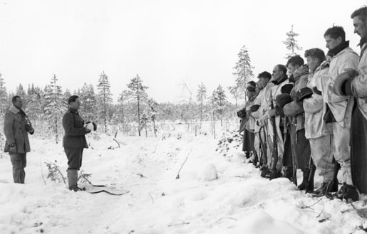 Finnish Army Lieutenant Aarne Juutilainen and his company holding a Christmas service near the Kollaa River, Finland, 24 Dec 1939 (public domain via WW2 Database)