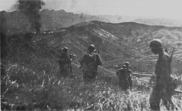 US troops on hill overlooking Damortis-Rosario Road on Luzon (US Army Center of Military History)