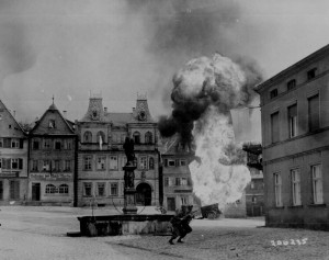 Men of US 101st Infantry Regiment running past a burning fuel trailer in square of Kronach, Bayreuth, Germany, 14 Apr 1945 (US National Archives: 111-SC-206235)