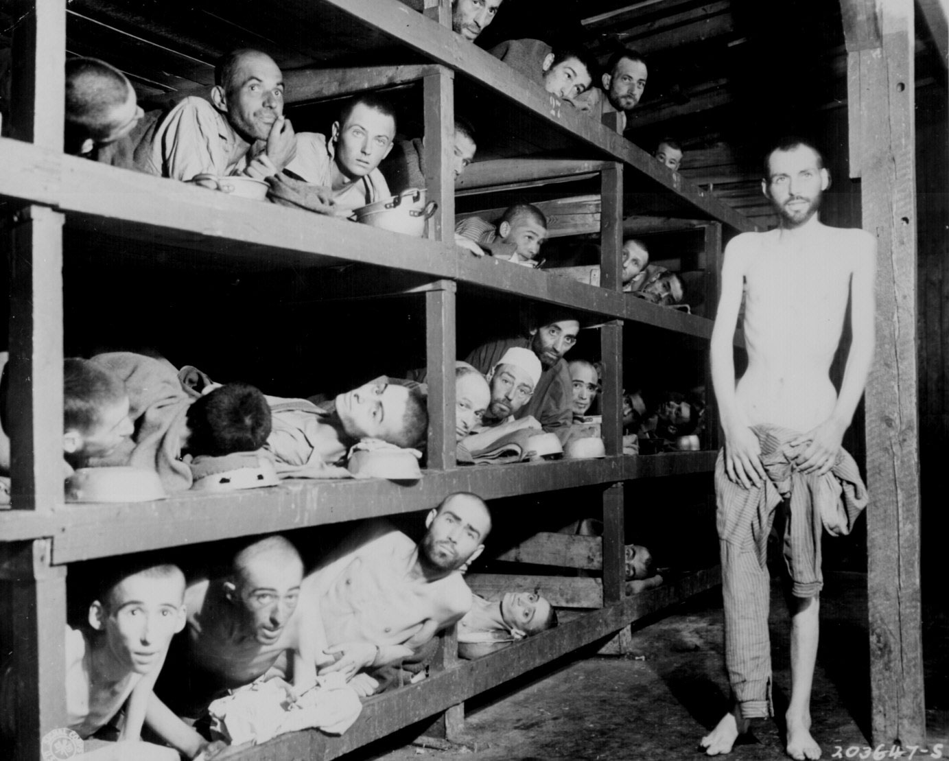Prisoners at Buchenwald concentration camp, Germany, 16 Apr 1945; author Elie Wiesel is in the second row up, seventh from the left, next to the bunk post (US National Archives: 208-AA-206K-31)