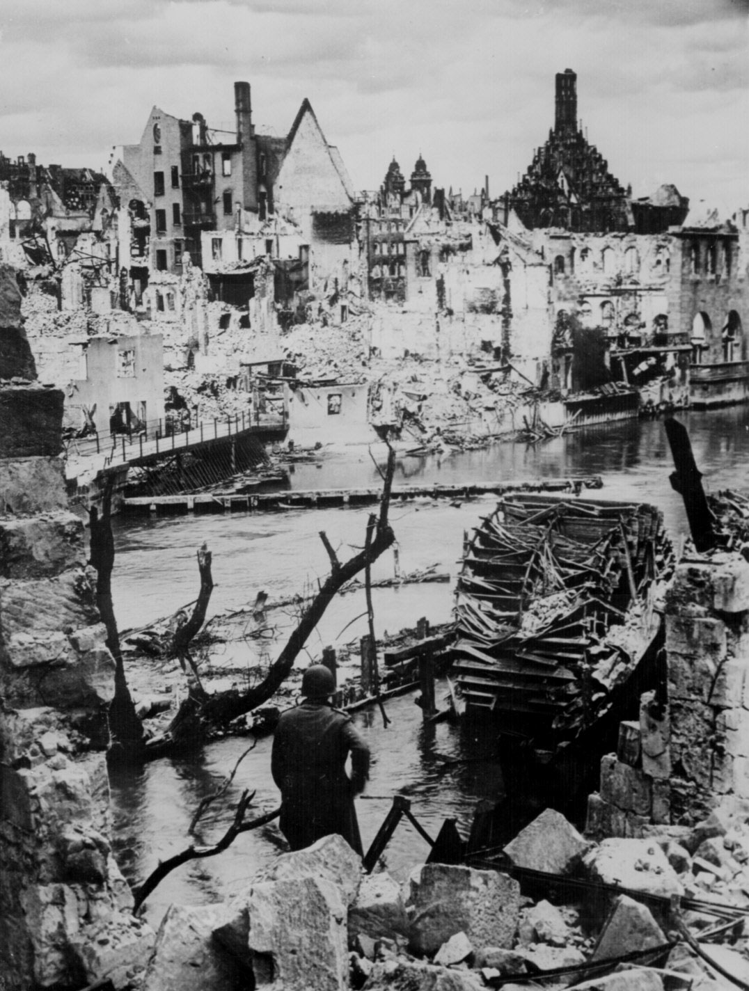 An American soldier observed the destruction of an industrial town near Nuremberg, Germany, 20 Apr 1945 (US National Archives: 208-AA-207L-1)