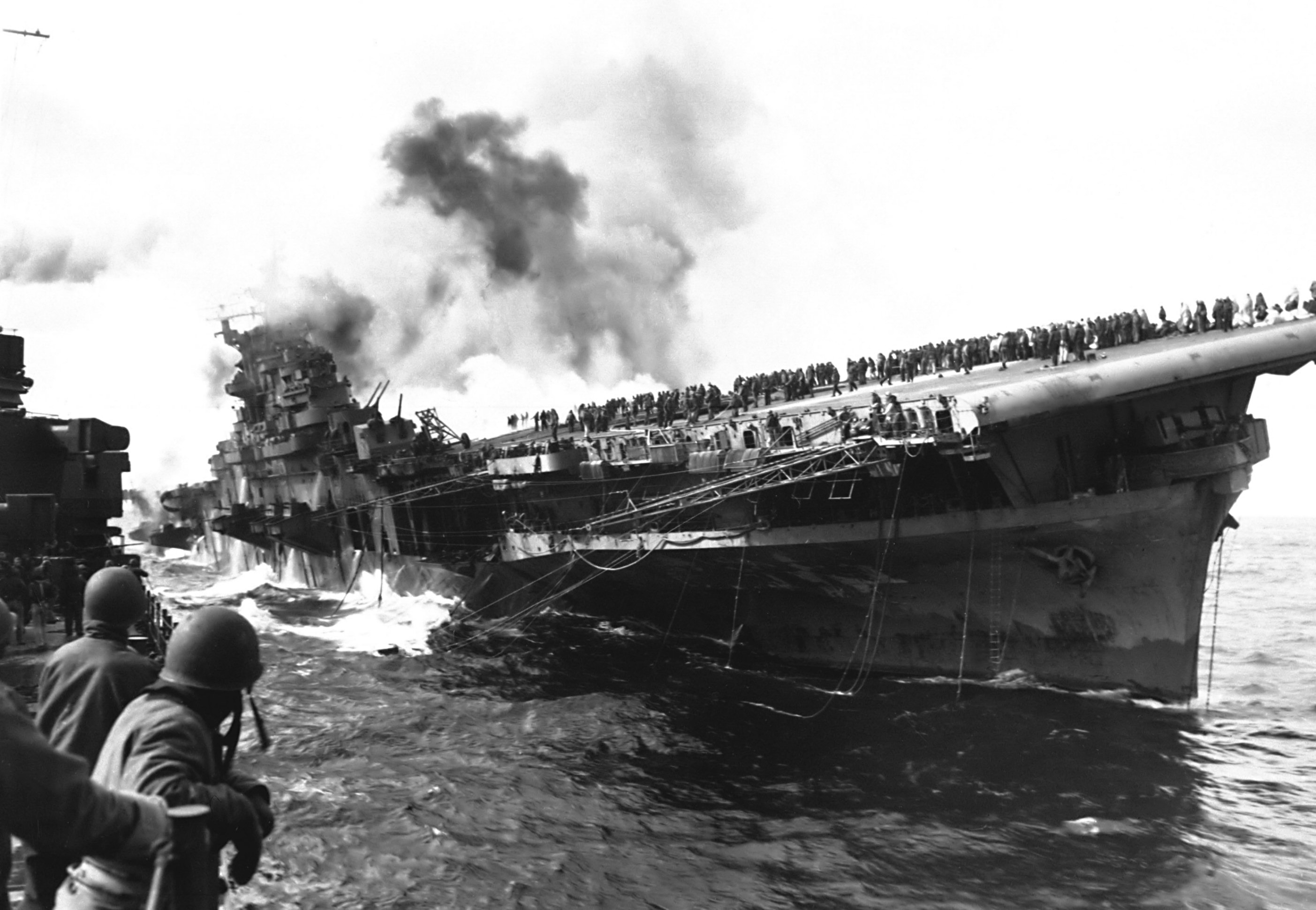 Damaged carrier USS Franklin off Japan, 19 Mar 1945; photograph taken from cruiser USS Santa Fe (US National Archives: 80-G-273880)