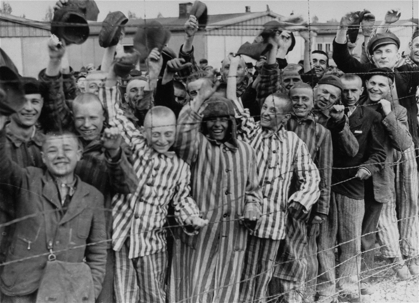 Prisoners celebrating the arrival of United States Army troops, Dachau Concentration Camp, Germany, 29 Apr 1945 (US Holocaust Memorial Museum: 45075)