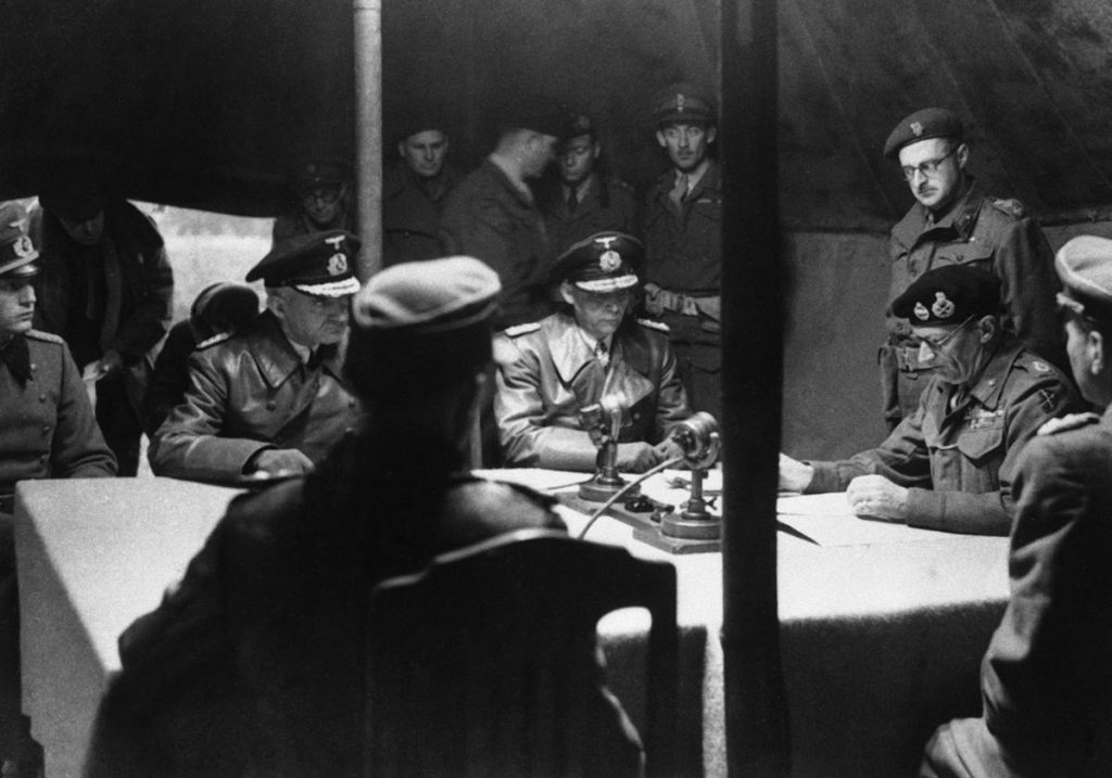 Gen. Bernard Montgomery reading surrender document to German officers at British 21st Army Group headquarters, Lüneburg Heath, Germany, 4 May 1945 (Imperial War Museum: BU 5208)