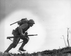 US Marine running through Japanese fire at ‘Death Valley,’ Okinawa, Japan, 10 May 1945 (US National Archives: 41607-FMC)