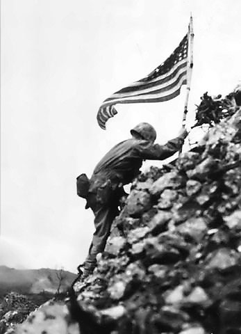 US Marine Lt. Col. R. P. Ross Jr. raising the US flag over Shuri castle on Okinawa, 29 May 1945 (US National Archives: FMC 42043)