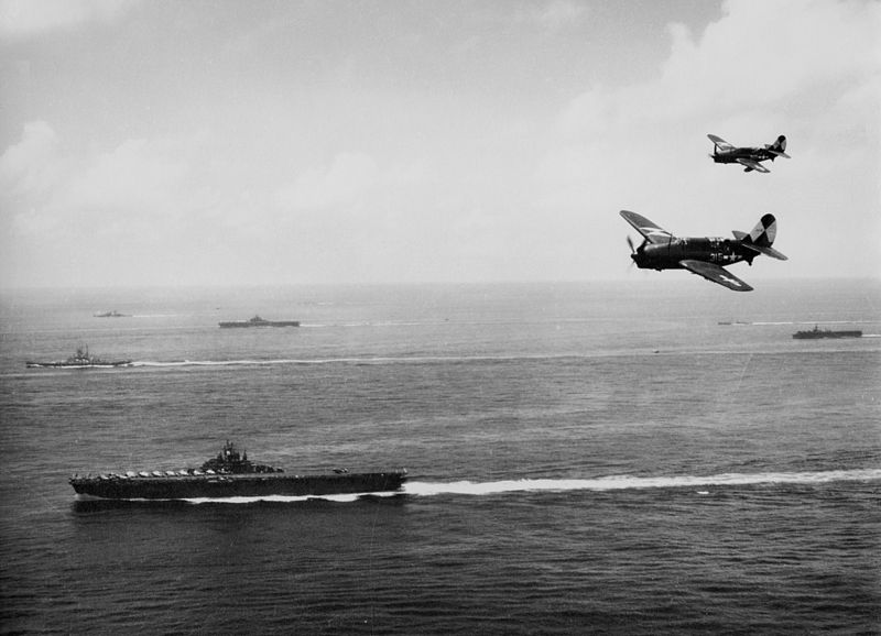 US Navy TG 38.3 off Okinawa, May 1945. US Navy Curtiss SB2C-4 Helldiver dive bombers from carrier USS Essex. Background: battleship USS Washington, an Essex-class carrier, and an Independence-class light carrier (US Navy photo 1996.253.360)