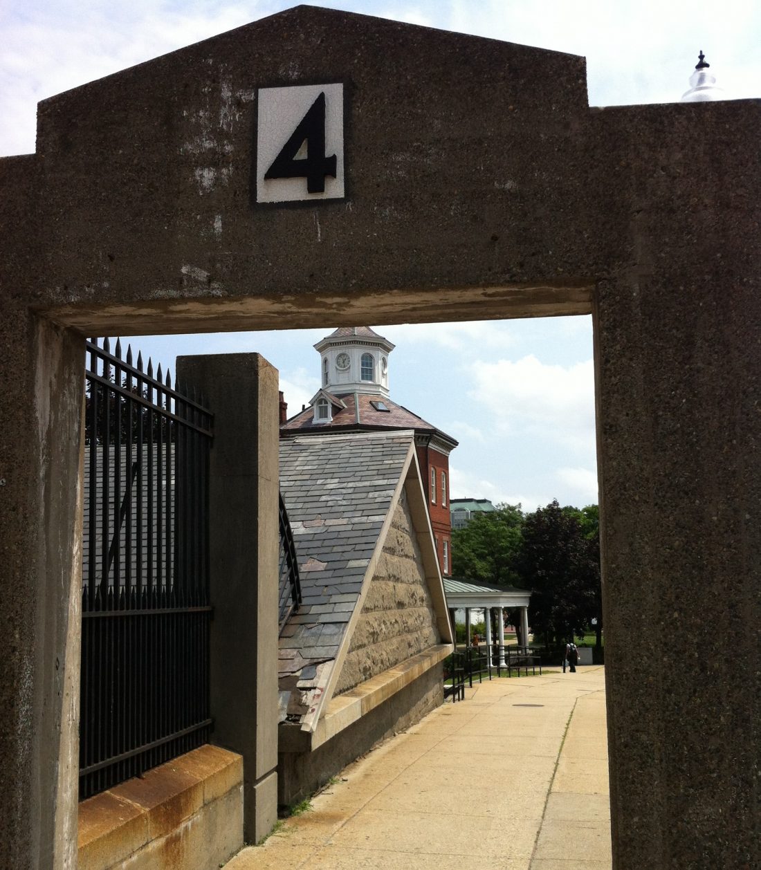 Gate 4 at the Charlestown Navy Yard in Boston. Through the gate you can see the Ropewalk and the Muster House (Photo: Sarah Sundin, July 2014)