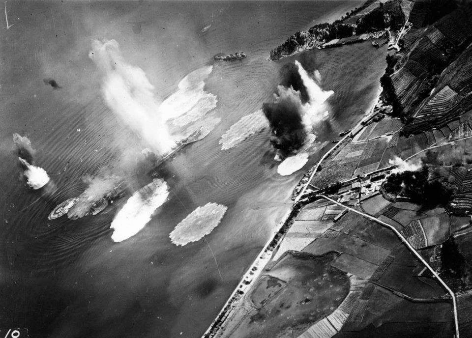 Japanese cruiser Tone under air attack near Kure, Japan, 24 Jul 1945; photo taken by USS Shangri-La aircraft. (US National Archives: 80-G-490147)