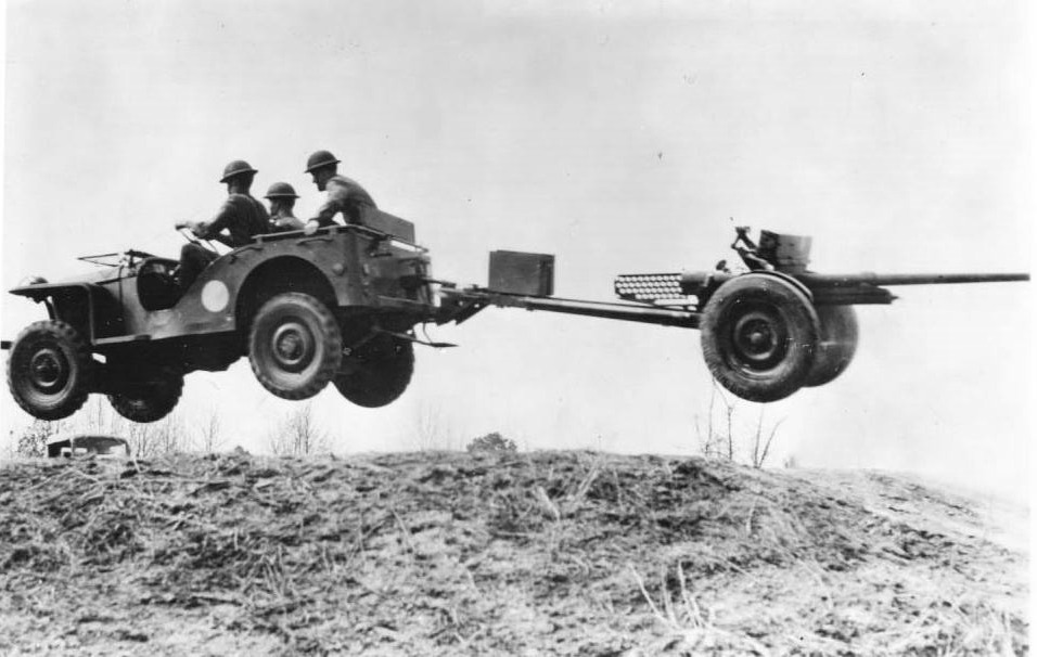 Bantam jeep, towing a 37 mm Gun M3 piece, jumping over a small hill, New River, NC, 1941 (Library of Congress) 