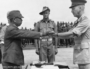 Lt. Gen. Hatazo Adachi symbolically surrenders his sword to Australian Maj. Gen. H.C.H. Robertson at Wom Airstrip, New Guinea, 13 September 1945 (Australian War Memorial: 019296)