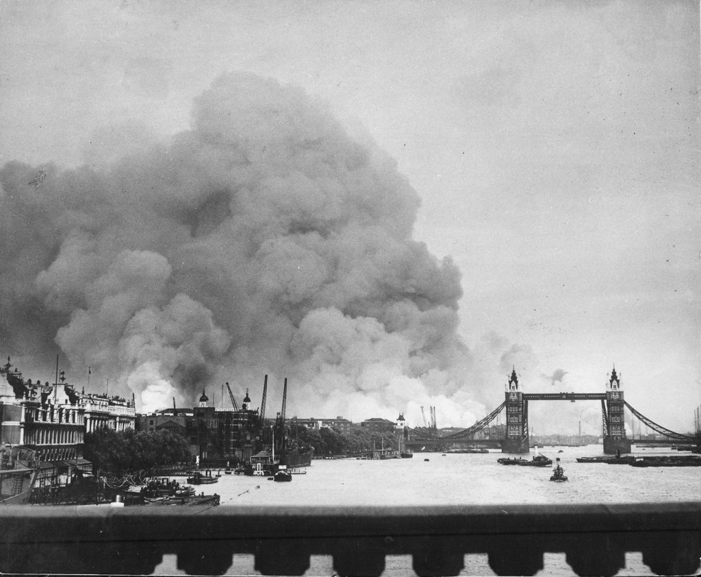 Smoke rising from the Surrey Docks, London, England, 8 Sep 1940, the morning after the opening night of “The Blitz,” with the Tower Bridge silhouetted against the smoke (US National Archives: 541917)