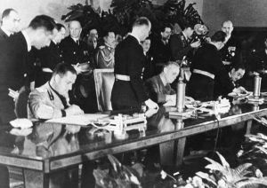 Galeazzo Ciano of Italy, Joachim von Ribbentrop of Germany, and Saburō Kurusu of Japan signing the Tripartite Pact at the Reich Chancellery in Berlin, 27 Sep 1940 (public domain via WW2 Database)