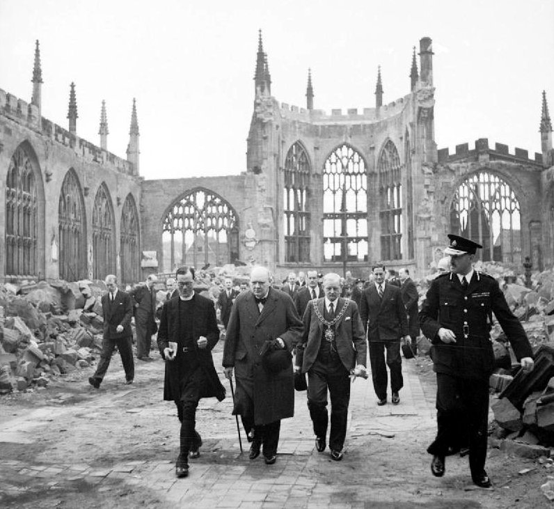 Winston Churchill in the ruined nave of Coventry Cathedral, England, severely damaged in air raid, 14–15th November 1940 (Imperial War Museum: H 14250)