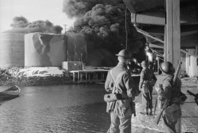 Raid on the Lofoten Islands: British Commandos watching fish oil tanks burning, 4 March 1941 (Imperial War Museum: N 396)