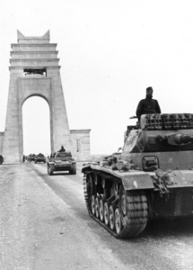 Panzer Mk IIIs and Mk IIs cross under the Marble Arch at Sirte, Libya, 21 March 1941 (German Federal Archive: Bild 101I-782-0009-01A)