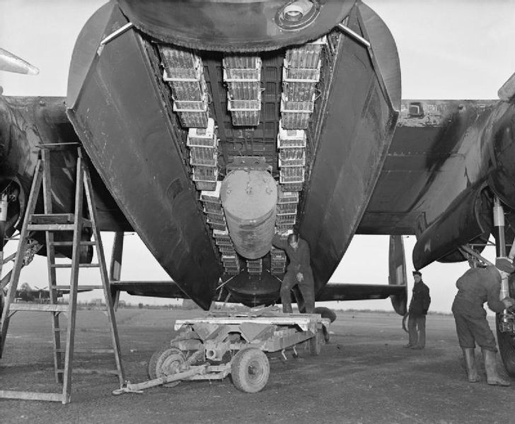 Bomb bay of an Avro Lancaster of No.57 Squadron RAF at Scampton, Lincolnshire, loaded with a 4000-lb impact-fused HC bomb (‘cookie’) and 12 Small Bomb Containers (SBCs) loaded with incendiaries, WWII (Imperial War Museum: CH 18371)