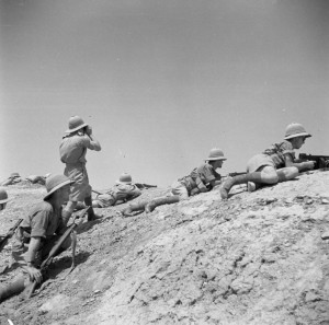 A firing party provide cover for Royal Engineers building bridge near Ramadi, Iraq, 1 June 1941. (Imperial War Museum)