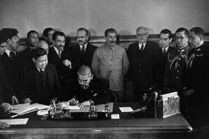 Japanese Foreign Minister Matsuoka signing the Soviet-Japanese Neutrality Pact, 13 Apr 1941, Molotov and Stalin in background (public domain via Russian Archives and Wikipedia)